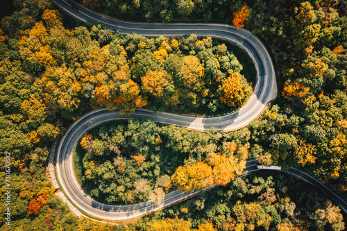 Extreme curved winding road in the forest as seen from above