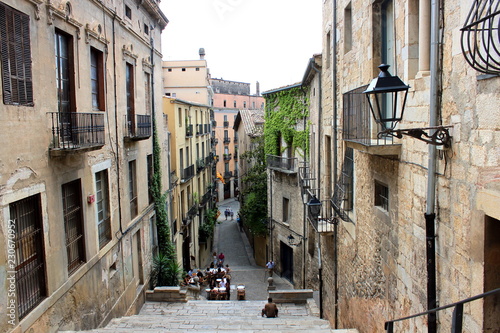 Girona. View to the street, ancient buildings, stone stairs, historic center, Pujada De Sant Domenec or Escalinata De Sant Marti. photo