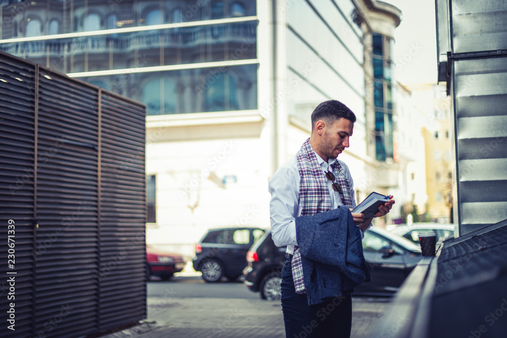 Good looking businessman looking at his notebook Good looking businessman looking at his notebook