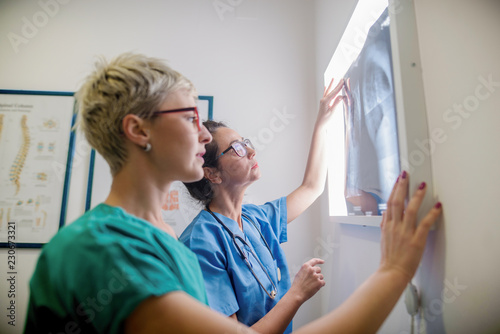 Orthopedists looking at X-ray.  Consulting room interiour. photo