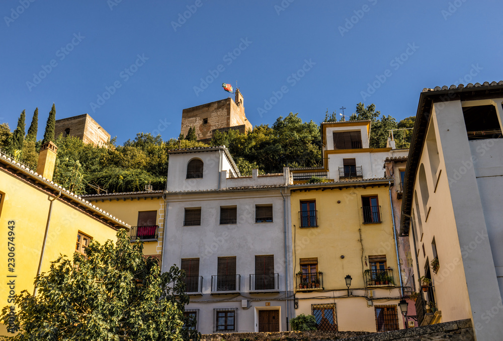 Royal Alhambra Palace above a neighborhood in Granada, Spain