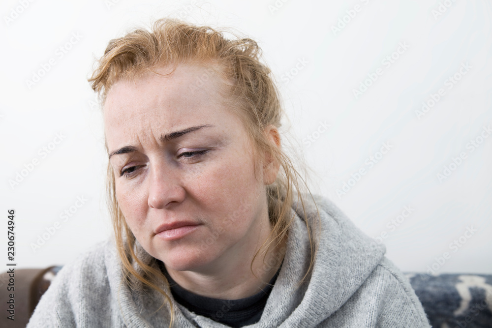 Woman with headache. Housewife woman in a couch with headache and a hand on forehead. Woman with headache. Housewife woman in a couch with headache and a hand on forehead.