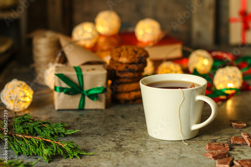 tea in a white cup (tea bag) gifts on the table. holiday atmosphere. top image. food background