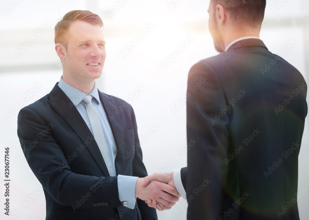 handshake financial partners in the corridor of the office handshake financial partners in the corridor of the office
