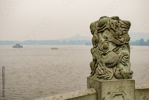 Dragon sculpture on the top of stone railing around West Lake in Hangzhou China.
