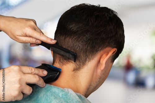 Man having a haircut with scissors on