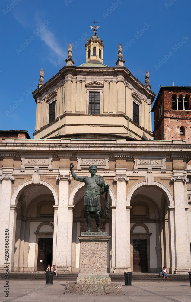 Facade of San Lorenzo Maggiore Basilica -Saint Lawrence the Major Cathedral- and statue of Constantine emperror in front.