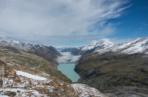 View to Stausee lake near Saas Fee in the southern Swiss Alps from Monte Moro pass  Italy