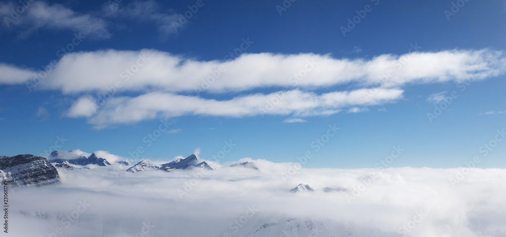 Panoramic view on sunlight mountains under clouds Panoramic view on sunlight mountains under clouds