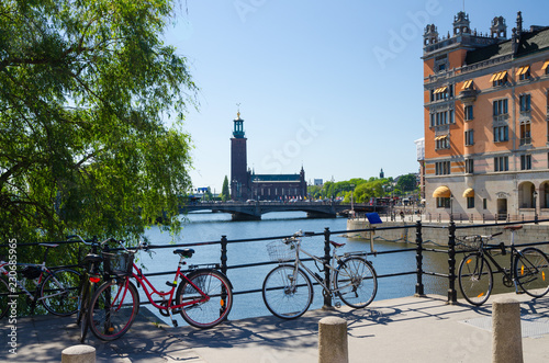Bikes near bridge railing and Stockholm City Hall Stadshuset, Sweden