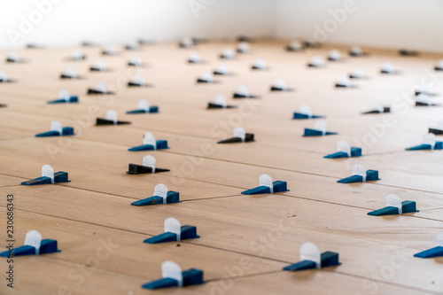 Tile leveling system with plastic clips and wedges, shot while the tile mortar sets
