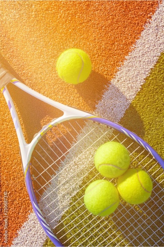 Tennis game. Tennis balls and racket on court background. © BillionPhotos.com