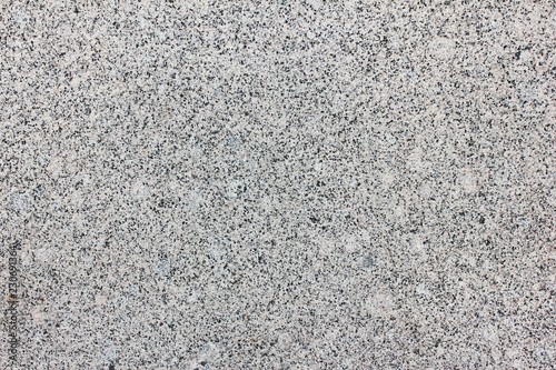Granite Texture Close Up View of Light Grey and White Mineral Stone. Simple Stoned Surface of Natural Granite Material Background. Abstract Empty Seamless Pale Backdrop Top View with Empty Copy Space