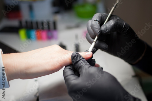 Manicure. Close-up Of Female Hands Filing Nails With Nail File In Beauty Salon. Nail Care Tool. High Resolution