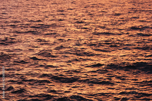 Water Surface with Sunset Light Reflection. River or Sea Water Beautiful Pattern with Small Waves on Evening Dusk. Natural Calm Water Background, Empty Wallpaper of Soft Sun Colors on Water Surface