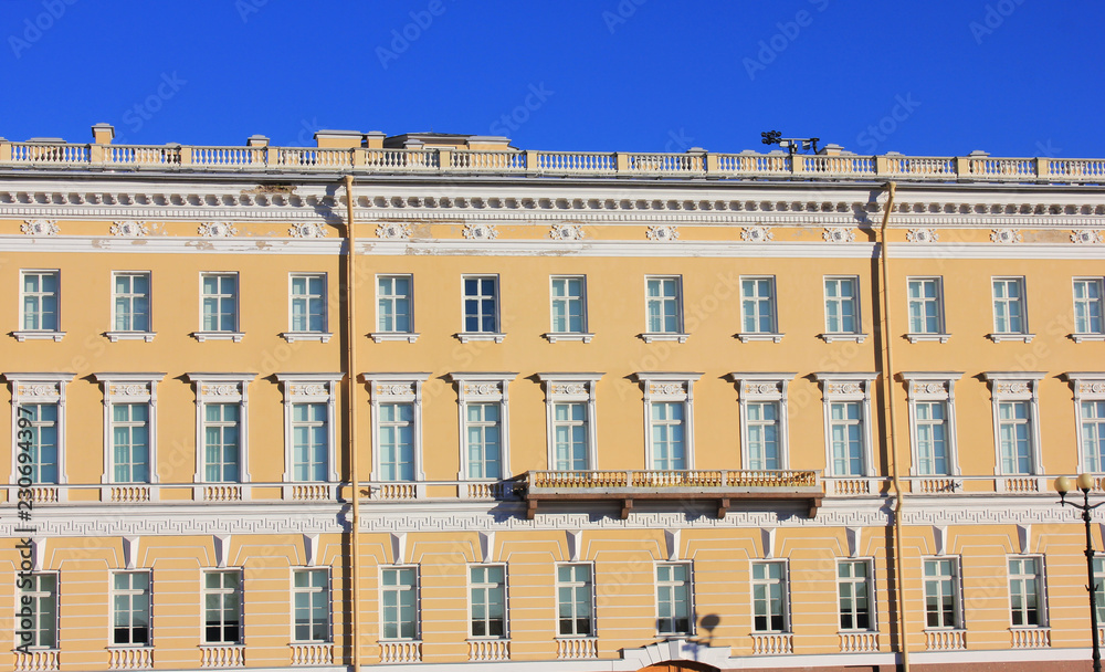 Classical Building Facade Architecture of Old Historic House with Pale Beige Colored Walls. Exterior Design and Elements of Apartment Building Front View. Minimalist Style European Architecture