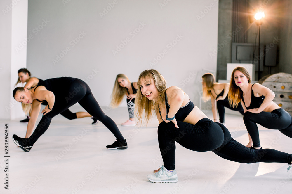 Naklejka premium Fitness, sports, health, fitness and lifestyle concept. Beautiful Caucasian, European girls. Stretching workout indoors