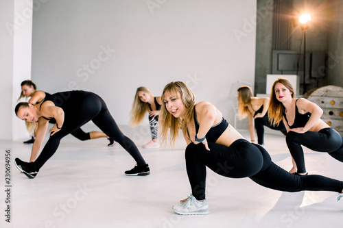 Fitness, sports, health, fitness and lifestyle concept. Beautiful Caucasian, European girls. Stretching workout indoors