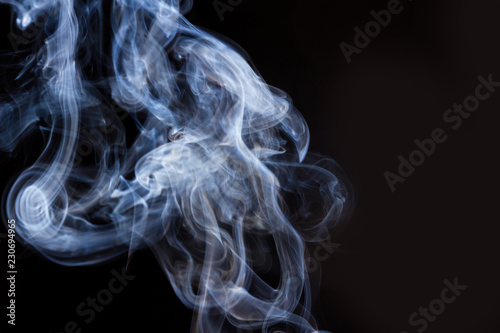 Thick smoke on a black isolated background. Background from the smoke of vape © goodwin_x