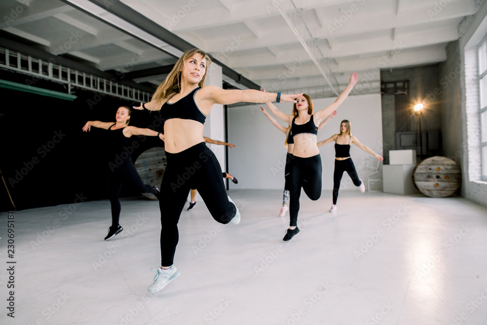Naklejka premium Team of women having step aerobics class