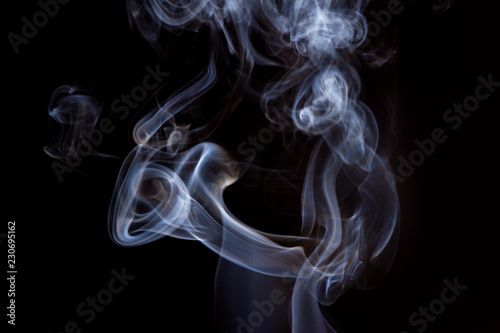 Thick smoke on a black isolated background. Background from the smoke of vape
