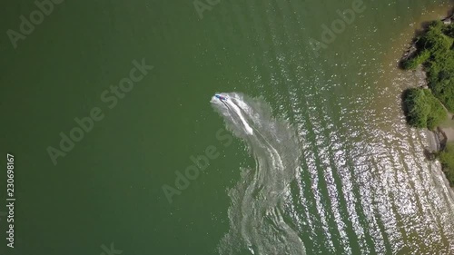 Top down aerial view of person having fun on a jet ski photo