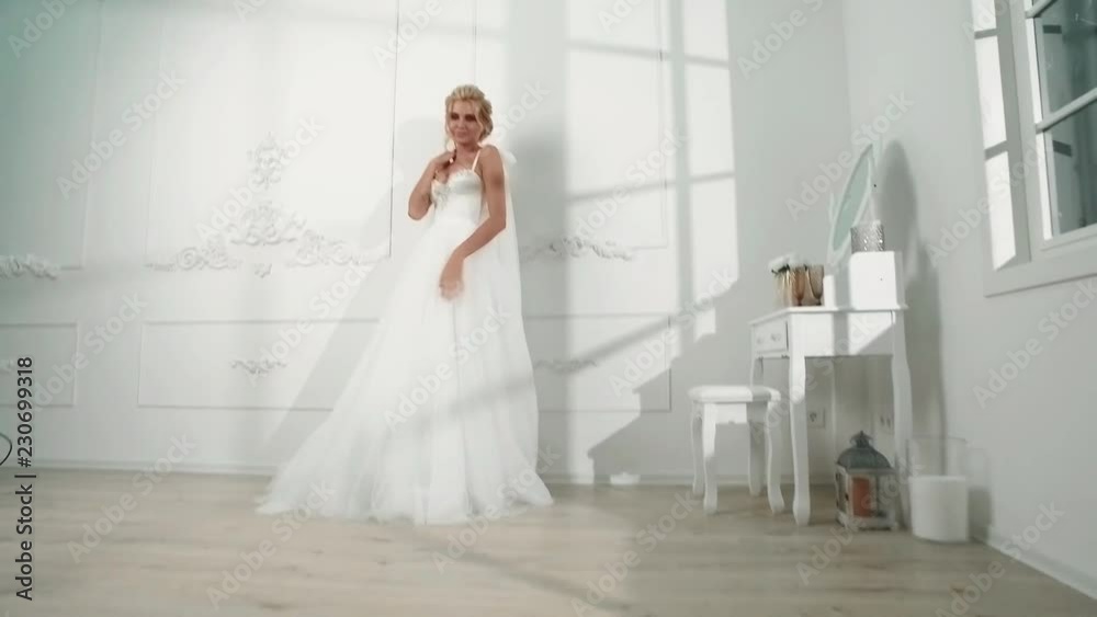 beautiful sexy blonde bride posing in wedding dress with bouqet beautiful sexy blonde bride posing in wedding dress with bouqet