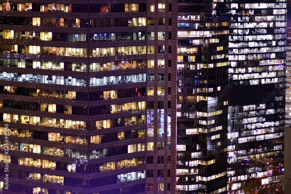 Office building at night. Late night at work. Glass curtain wall office building Office building at night. Late night at work. Glass curtain wall office building
