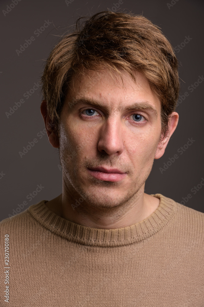 Portrait of handsome man against gray background Portrait of handsome man against gray background