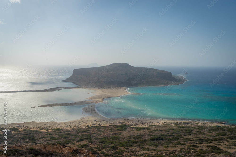 Gramvousa Peninsula, Crete - 09 25 2018: Balos Lagoon in windy weather. beach umbrellas
