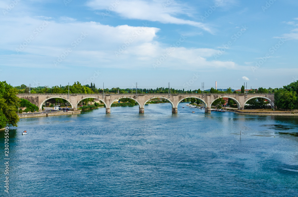 The railway bridge crossing the river Mincio at Peschiera del Garda, Italy