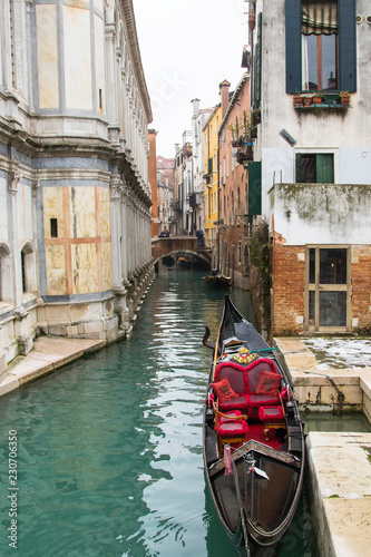 Gondola in a little canal of Venice