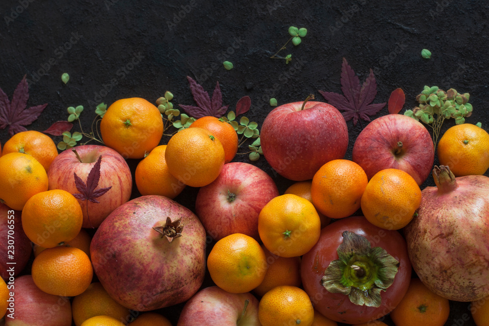 Italian autumn harvest: garnet, mandarins, persimmons, apples.
