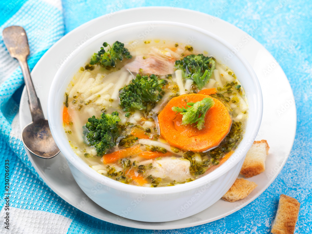 Italian vegetable soup with broccoli carrots and noodles in chicken broth