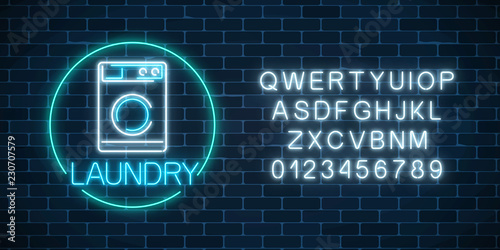 Neon glowing laundry signboard in circle frame with alphabet. Illuminated self-service washhouse sign
