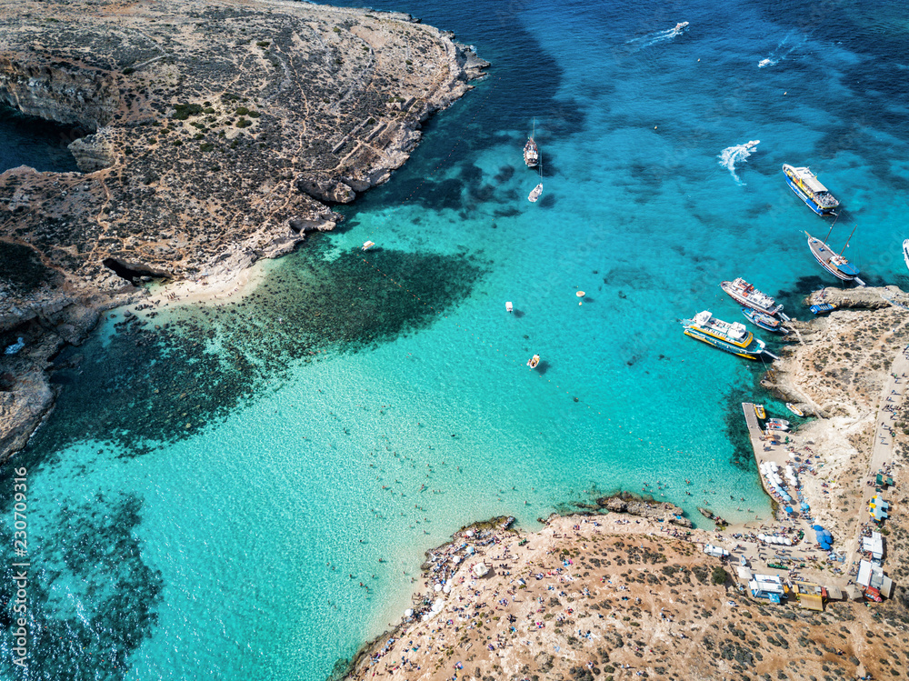 Aerial drone photo - The famous Blue Lagoon in the Mediterranean Sea.  Comino Island, Malta.      - obrazy, fototapety, plakaty 