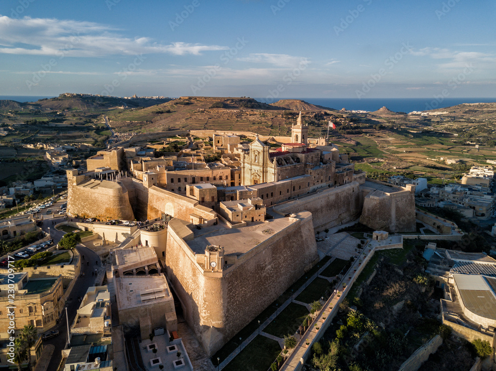 Aerial drone photo - The Gozo Citadel at sunset. A medieval fortress in the  city of Victoria (Rabat). Island of Gozo, Malta. Stock Photo | Adobe Stock