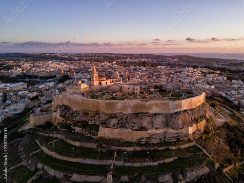 Obraz na płótnie Aerial drone photo - The Gozo Citadel at sunset. A medieval fortress in the city of Victoria (Rabat). Island of Gozo, Malta. w salonie