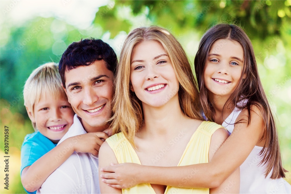 Obraz premium Beautiful smiling Lovely family in park