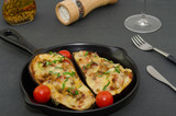 Roasted eggplant stuffed with vegetables, bacon and mozzarella cheese. Baked eggplant with cheese, meat and tomatoes.  