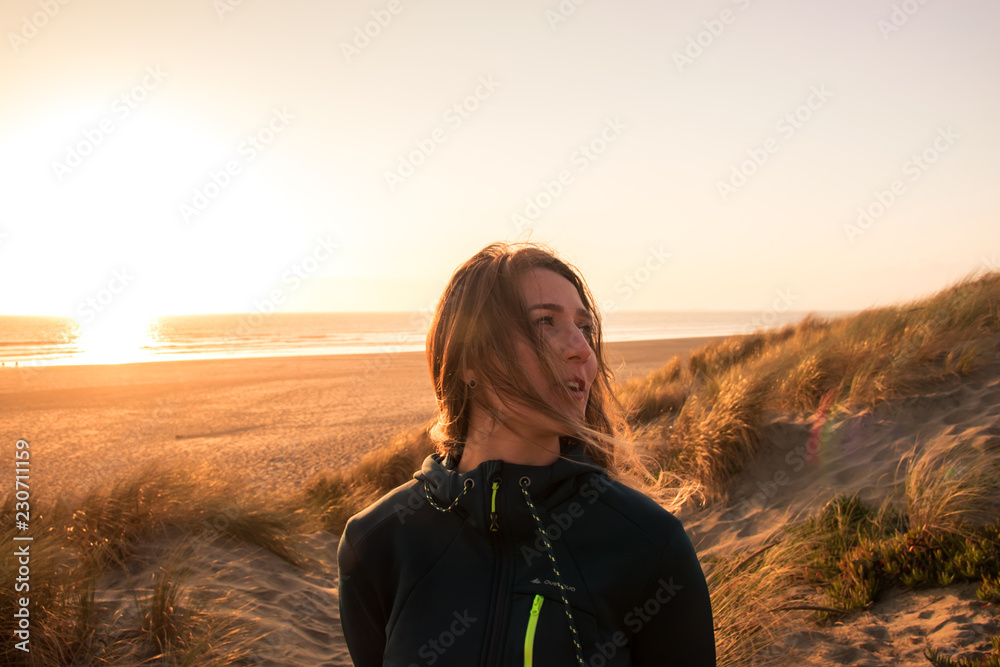 Woman smiling at sunset on the beach