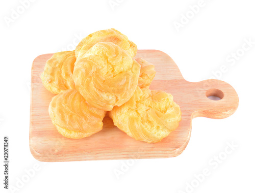 Foto Cream puff with filling on wood isolated on white background