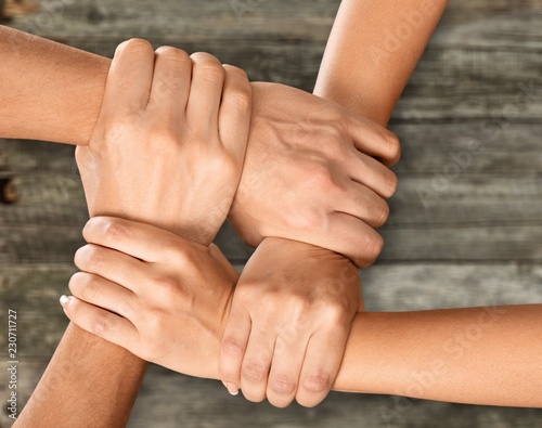 Group of people stacking hands together