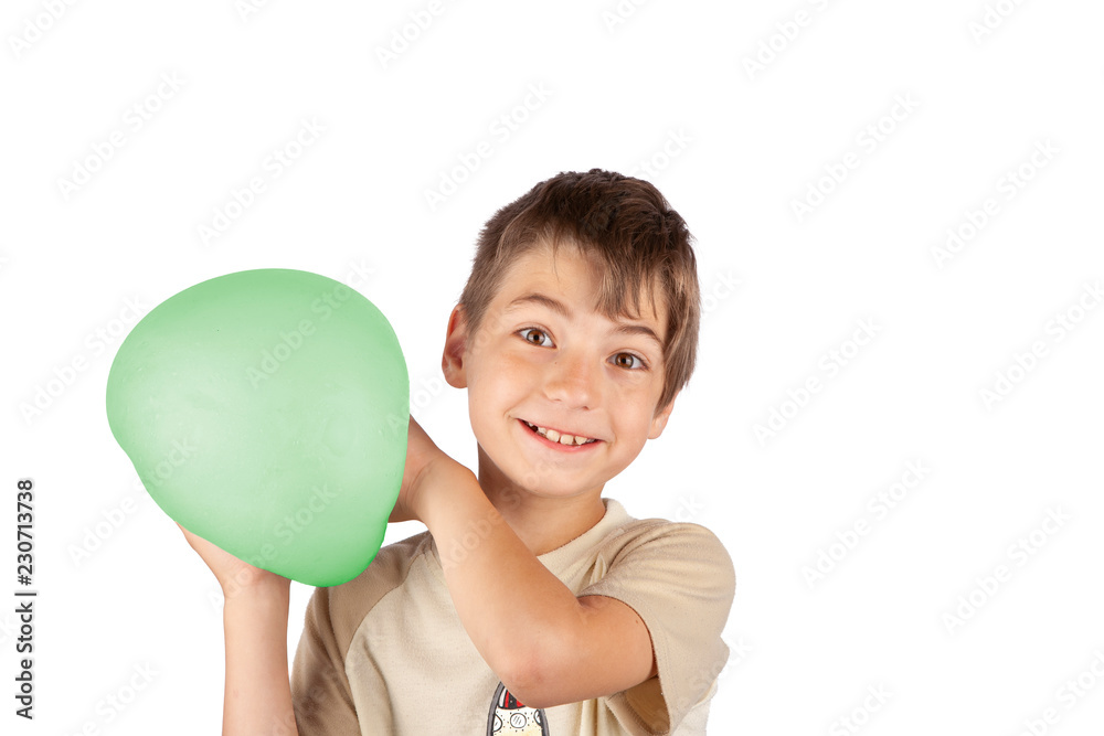 Cheerful young boy holding a green slime balloon. Studio shot isolated on white background. Cheerful young boy holding a green slime balloon. Studio shot isolated on white background.