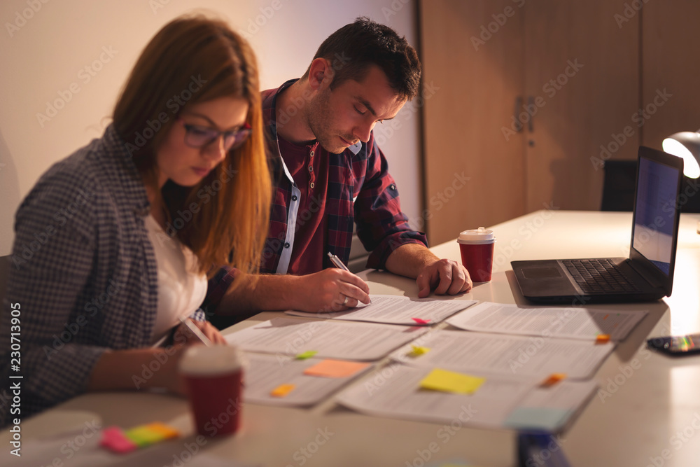 Business colleagues working overtime on a project Business colleagues working overtime on a project