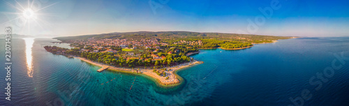 Aerial view of seaside promenade in Supetar town on Brac island with palm trees and turquoise clear ocean water, Supetar, Brac, Croatia, Europe photo