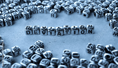 Deviation - Word from Metal Blocks on Paper - Concept Photo on Table
