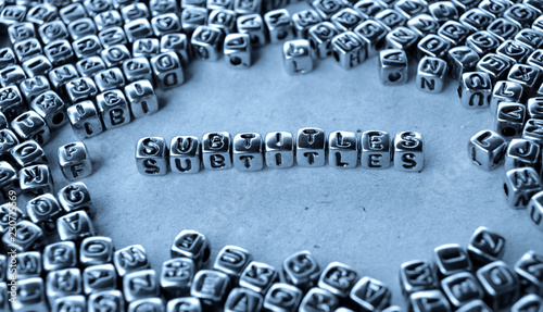 Subtitles - Word from Metal Blocks on Paper - Concept Photo on Table
