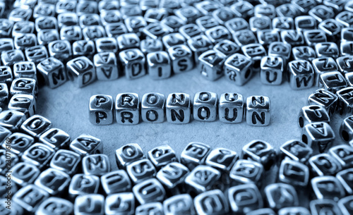 Pronoun - Word from Metal Blocks on Paper - Concept Photo on Table
