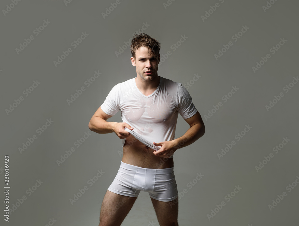 Strong athletic man in underwear. Sexy erotic handsome man in wet t-shirt.  Sensual man in underwear. Muscular male model in white underwear. Men's  swimwear and underwear. Man in boxer shorts. Fashion. Photos